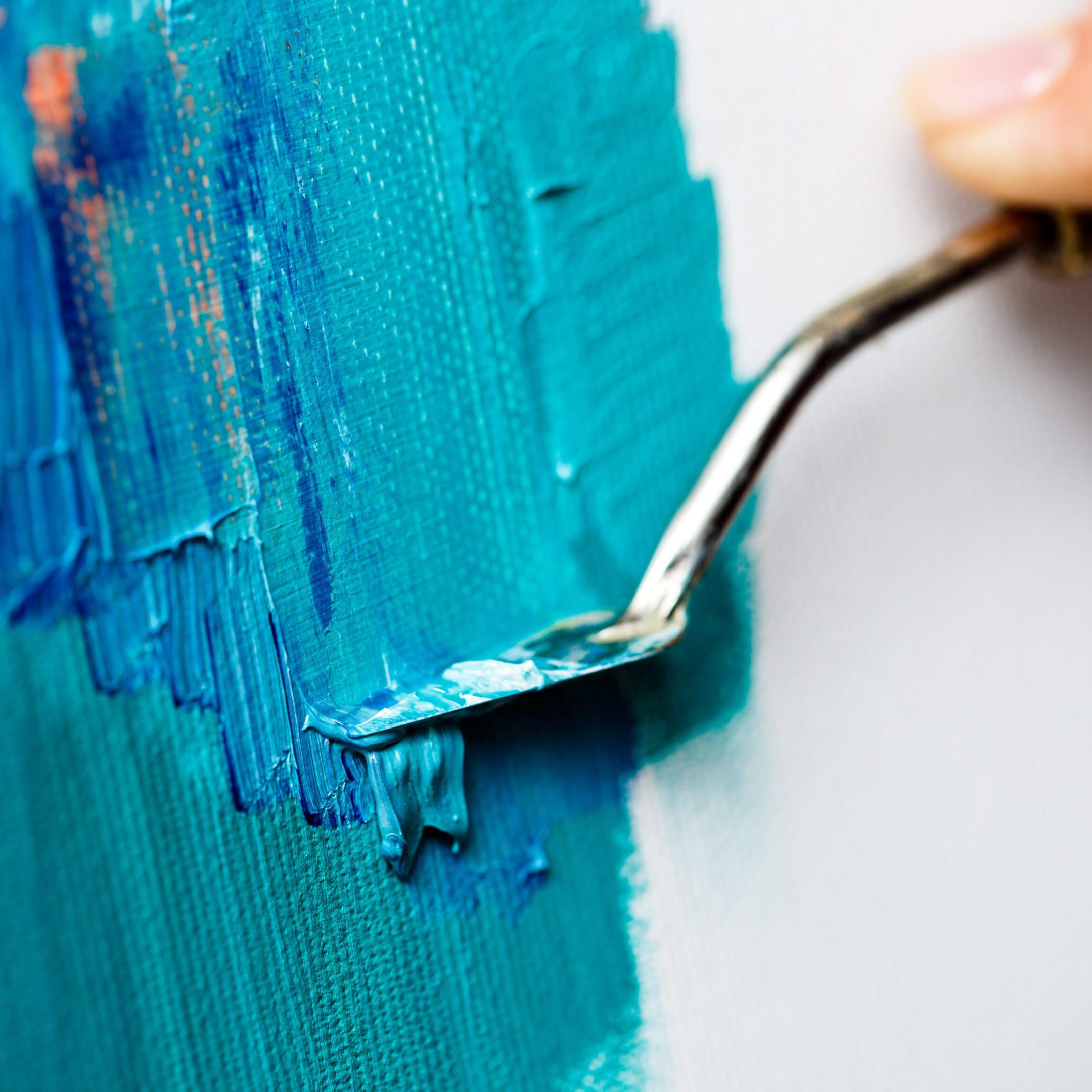 Close up photo of girl drawing with oil paints on canvas. Copy space.