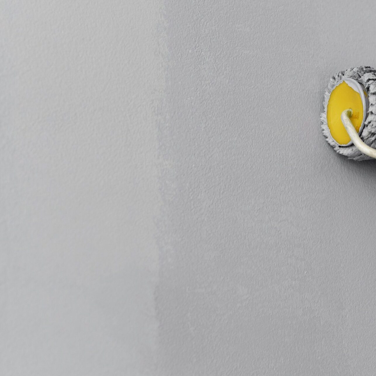 roller-painting-gray-wall