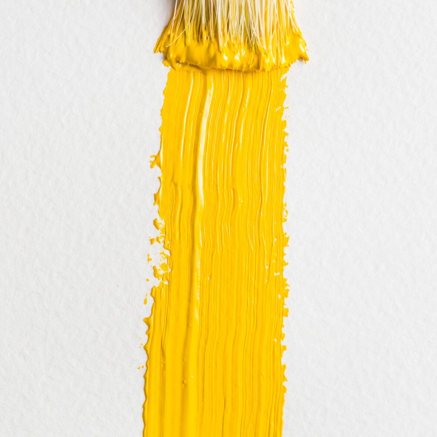 textured-smear-yellow-paint-near-brush